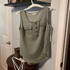 Green sleeveless top.